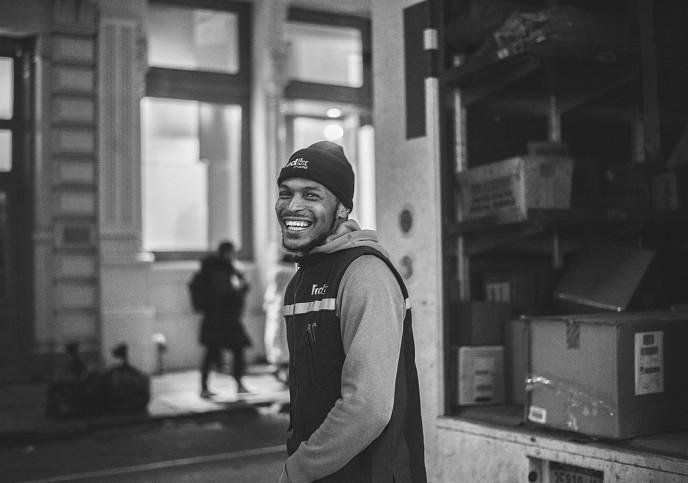 Man smiling in front of delivery truck